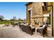 Outdoor lounge area with stone fireplace, comfortable seating, and views of the golf course at 32 Eagle Dr, Littleton, CO 80123