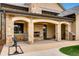 Covered patio with a stone fireplace, comfortable seating, and views of the surrounding landscape at 32 Eagle Dr, Littleton, CO 80123