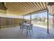 Covered patio features wrought iron table and chairs; ideal for outdoor dining at 32 Eagle Dr, Littleton, CO 80123