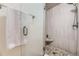 Modern shower with a glass door, stylish tile, and a convenient built-in seat at 32 Eagle Dr, Littleton, CO 80123