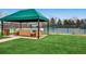Community tennis courts feature covered gazebo and ample seating for spectators at 32 Eagle Dr, Littleton, CO 80123