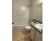 A bathroom with a tub-shower combo, white tiling, a toilet, and a vanity with a basic sink at 18193 E Kentucky Ave # 201, Aurora, CO 80017