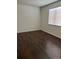 An empty bedroom with hardwood floors and a window with horizontal blinds at 18193 E Kentucky Ave # 201, Aurora, CO 80017