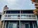 Exterior view of a condo building with a brick facade and a balcony with a white railing at 18193 E Kentucky Ave # 201, Aurora, CO 80017