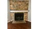 Stone fireplace with a black firebox and a light-colored mantel sits on wood floors at 18193 E Kentucky Ave # 201, Aurora, CO 80017