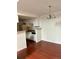 Dining area next to a kitchen with white cabinets and a stainless steel sink at 18193 E Kentucky Ave # 201, Aurora, CO 80017