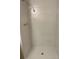This shower stall features white tiling and basic hardware, creating a clean, functional space at 18193 E Kentucky Ave # 201, Aurora, CO 80017