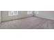 Spacious bedroom with neutral carpet, white walls, and bright natural light from multiple windows at 250 Chardon Ave, Brighton, CO 80601