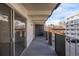 Large balcony of the condo with black railing and a view of the neighborhood at 1265 Race St # 208, Denver, CO 80206