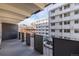 Balcony of the condo with black railing and views of the surrounding buildings at 1265 Race St # 208, Denver, CO 80206