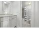This bathroom features updated fixtures, white cabinets, and tile flooring at 1265 Race St # 208, Denver, CO 80206