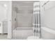 Nicely tiled bathroom and shower with a gray and white striped shower curtain at 1265 Race St # 208, Denver, CO 80206
