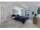 This staged bedroom features cozy carpet and an attractive accent wall at 1265 Race St # 208, Denver, CO 80206