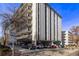 View of the condo building exterior with parking and nice landscaping at 1265 Race St # 208, Denver, CO 80206