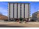 Modern high-rise apartment building with on-site parking and manicured landscaping at 1265 Race St # 208, Denver, CO 80206