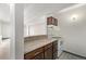 Efficient kitchen features wood cabinets, white appliances, and laminate countertops at 1265 Race St # 208, Denver, CO 80206