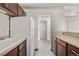 Bright kitchen features wood cabinets, white appliances, and neutral countertops at 1265 Race St # 208, Denver, CO 80206