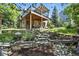 Landscaped backyard featuring a deck and patio, perfect for outdoor entertaining and enjoying the natural setting at 292 Summerwood Ln, Castle Pines, CO 80108
