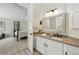 Bathroom featuring neutral countertop, vanity lighting, and bedroom access at 292 Summerwood Ln, Castle Pines, CO 80108