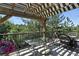 Outdoor deck featuring a pergola and wrought iron railings, perfect for relaxing and entertaining with views of trees at 292 Summerwood Ln, Castle Pines, CO 80108