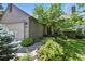 Inviting front yard with lush landscaping, a brick pathway, and charming exterior of home at 292 Summerwood Ln, Castle Pines, CO 80108