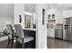 Modern kitchen with stainless steel appliances and barstool seating at counter at 292 Summerwood Ln, Castle Pines, CO 80108