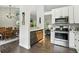 Kitchen features stainless steel appliances with adjacent dining area and fireplace at 292 Summerwood Ln, Castle Pines, CO 80108