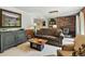 Cozy living room with brick fireplace, built-in shelving, comfortable seating, and stylish decor at 292 Summerwood Ln, Castle Pines, CO 80108
