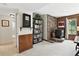Inviting living room with brick fireplace, bookshelves, and natural light from a window at 292 Summerwood Ln, Castle Pines, CO 80108