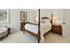 Bedroom featuring neutral carpet, four poster bed, and matching nightstands at 292 Summerwood Ln, Castle Pines, CO 80108