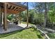 Relaxing outdoor patio surrounded by mature trees and a lush lawn, ideal for peaceful moments in nature at 292 Summerwood Ln, Castle Pines, CO 80108