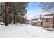 Exterior of townhome with snowy yard and trees at 1470 S Quebec Way # 83, Denver, CO 80231