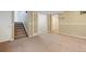 Basement area with carpet, stairs, white doors, and natural lighting at 4786 S Yampa St, Aurora, CO 80015