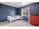 Bedroom with natural light and painted blue walls and an adorable red dresser at 4786 S Yampa St, Aurora, CO 80015