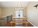 Spacious dining area with wooden table, bench seating, and elegant lighting fixture at 4786 S Yampa St, Aurora, CO 80015