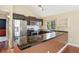 Modern kitchen with stainless steel appliances, dark countertops, and ample cabinet space at 4786 S Yampa St, Aurora, CO 80015