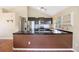 A well-appointed kitchen features stainless steel appliances and sleek, dark cabinetry for a modern feel at 4786 S Yampa St, Aurora, CO 80015