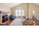 Living room with a brick fireplace, vaulted ceiling, comfortable seating, and wood floors at 4786 S Yampa St, Aurora, CO 80015