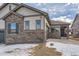 Home features stone and siding accents, a two car garage, and covered entry at 804 W 128Th Pl, Westminster, CO 80234