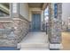 Dark green front door with stonework and a small covered porch at 804 W 128Th Pl, Westminster, CO 80234