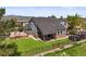 Aerial view of a spacious backyard with a well-maintained lawn, patio, and recreational features like a trampoline at 188 S Rogers Way, Golden, CO 80401