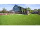 Expansive backyard featuring an outdoor kitchen, a fire pit, artificial grass, and a playset at 188 S Rogers Way, Golden, CO 80401