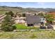 Expansive backyard with lush green lawn, basketball court, trampoline, and outdoor seating perfect for Gathering fun at 188 S Rogers Way, Golden, CO 80401