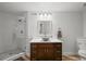 Bathroom featuring a modern vessel sink, wood cabinets, quartz countertop, and a glass-enclosed shower at 188 S Rogers Way, Golden, CO 80401