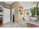 Bathroom featuring a soaking tub with granite countertops and an adjacent walk-in closet for added storage at 188 S Rogers Way, Golden, CO 80401