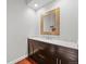 Stylish powder room with a dark wood vanity, marble countertop, decorative mirror, and modern fixtures at 188 S Rogers Way, Golden, CO 80401