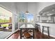Dining area with natural light from large windows, bar seating, and access to an outdoor living space at 188 S Rogers Way, Golden, CO 80401