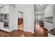 Bright interior view showcasing wood floors, white cabinets, and a glimpse of a laundry room with red washer/dryer at 188 S Rogers Way, Golden, CO 80401
