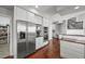 Open-concept kitchen features stainless steel appliances, a built-in desk, and a view of the staircase at 188 S Rogers Way, Golden, CO 80401