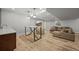 Finished basement with a bar, seating area, television and wood-look flooring at 188 S Rogers Way, Golden, CO 80401